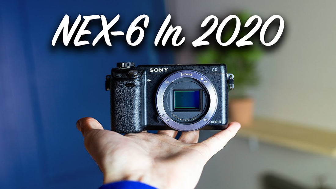 Sony NEX-6 camera body held in a hand beneath the words NEX-6 in 2020